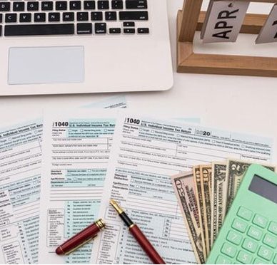 Calculator and 1040 Tax Forms on Desk for Tax Accounting Services